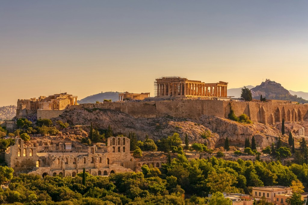 The Acropolis of Athens glowing at golden hour above the city