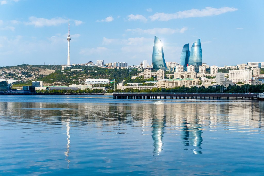 Baku skyline with the Flame Towers reflected in calm water