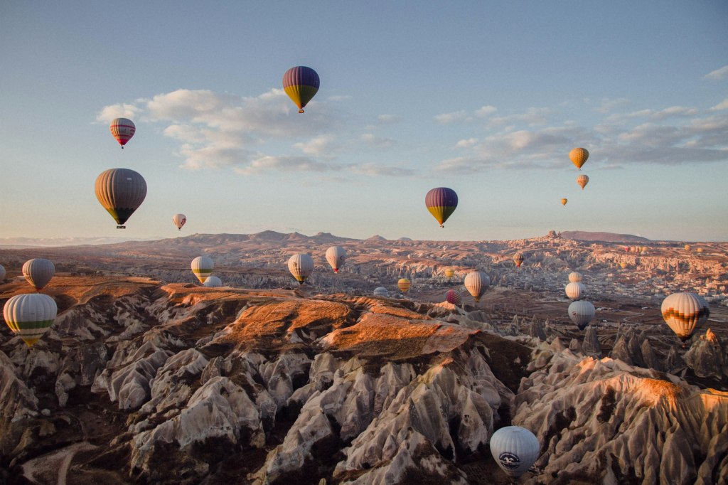Hot air balloons drifting over the valleys of Cappadocia, Turkey at sunrise