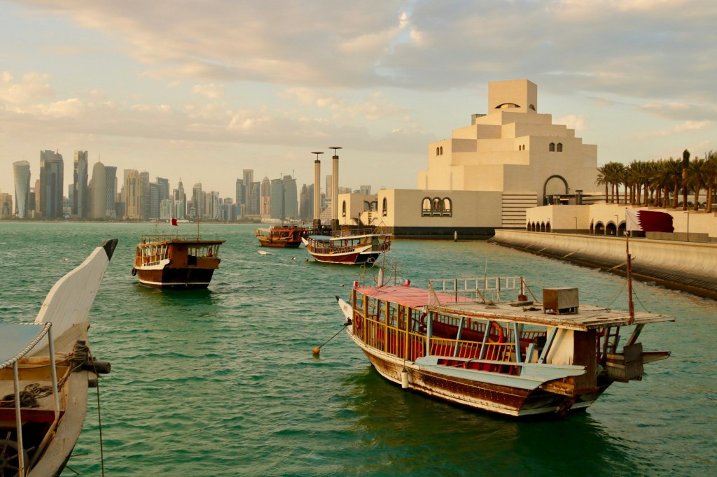 Traditional dhow boats on the water near the Museum of Islamic Art in Doha, Qatar