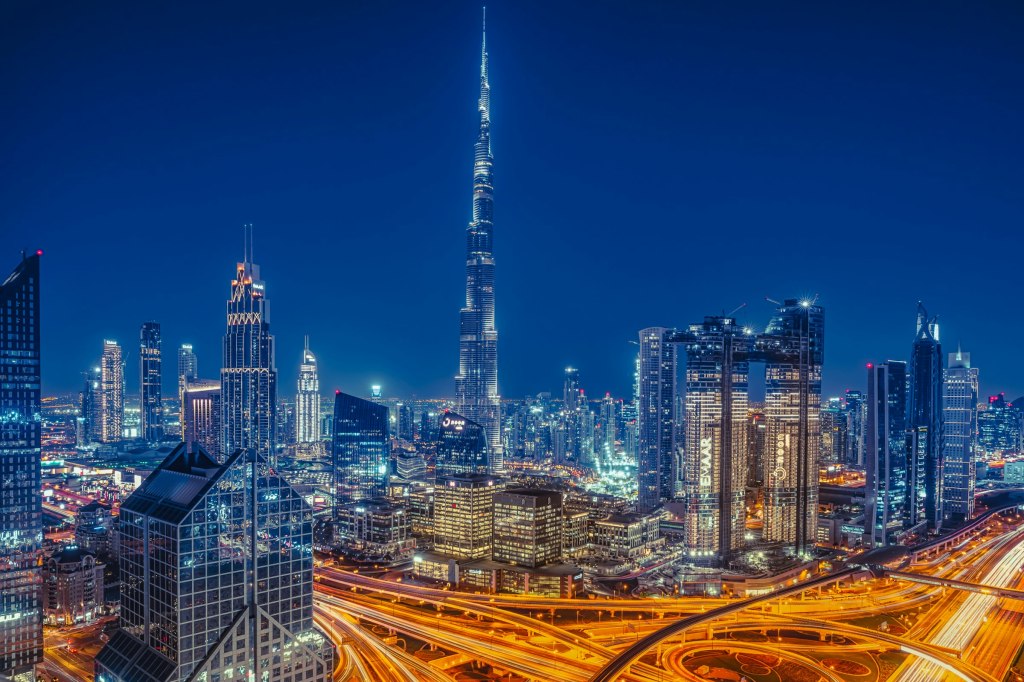 The Dubai skyline glowing at night, setting for fine dining in Dubai