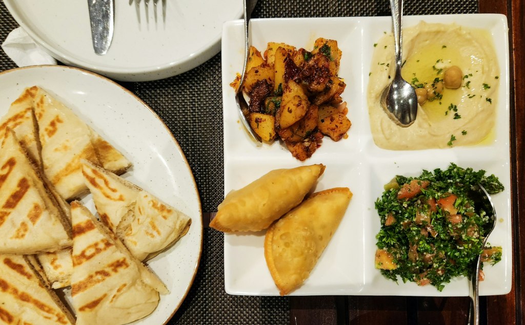 A platter of Levantine mezze dishes, evoking fine dining in Amman, Jordan
