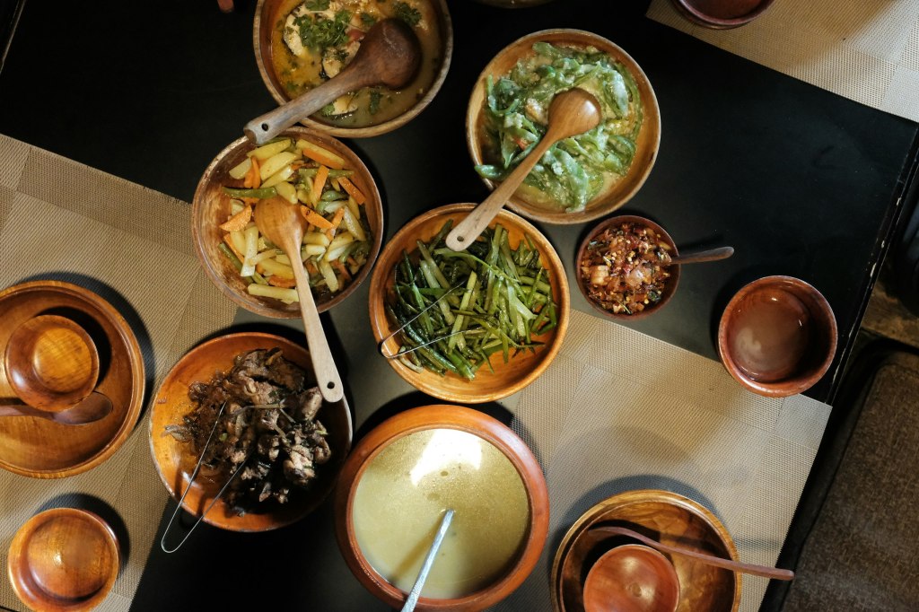 Georgian dishes served in wooden bowls for fine dining in Tbilisi