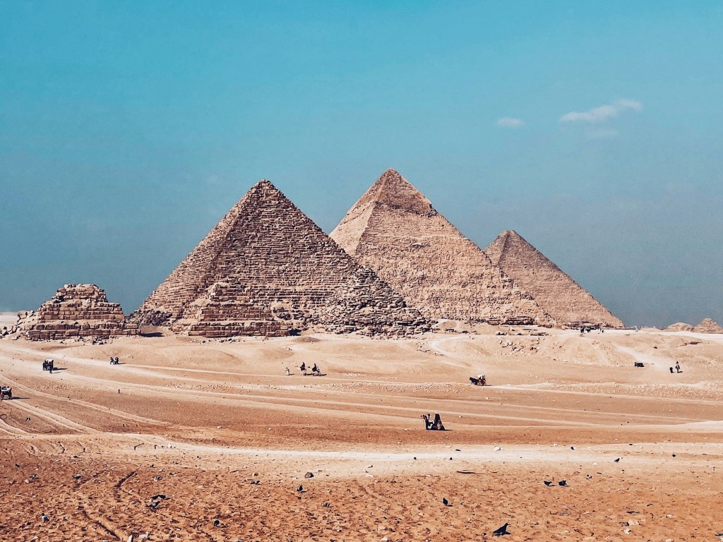 The Pyramids of Giza rising from the desert near the Grand Egyptian Museum, Egypt