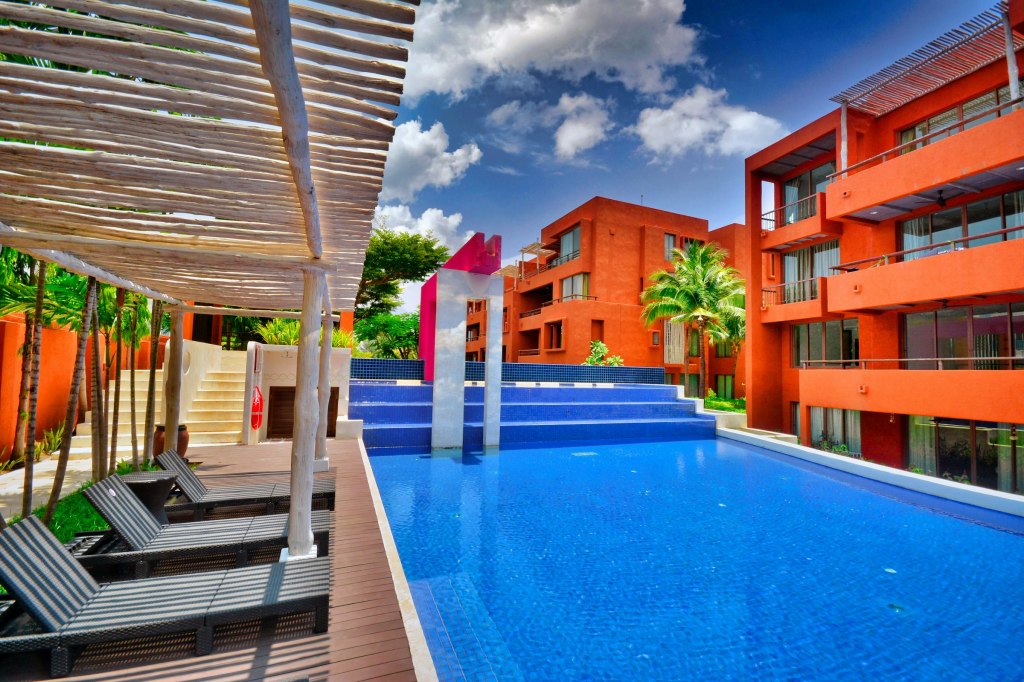 Resort swimming pool surrounded by palms in Hua Hin, Thailand