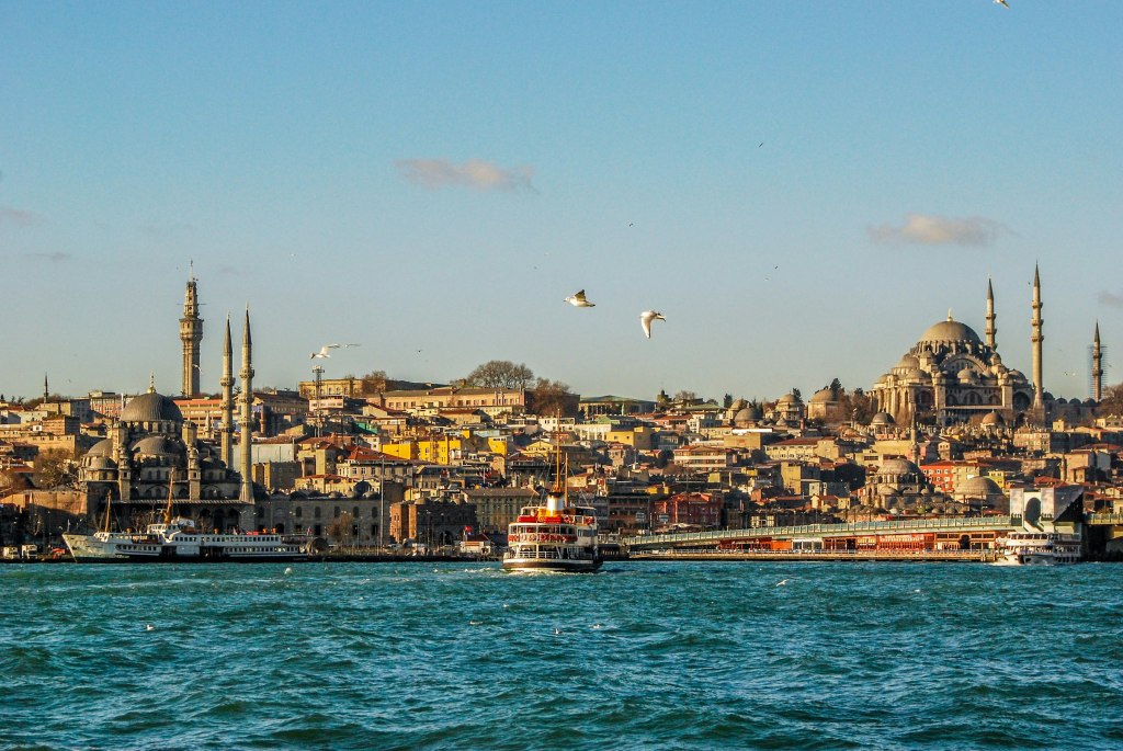 A ferry crossing the Bosphorus with the Istanbul skyline behind it