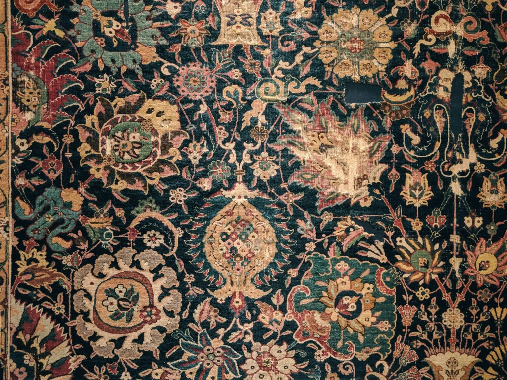 A richly patterned handwoven rug, in the spirit of Jordanian kilim weaving