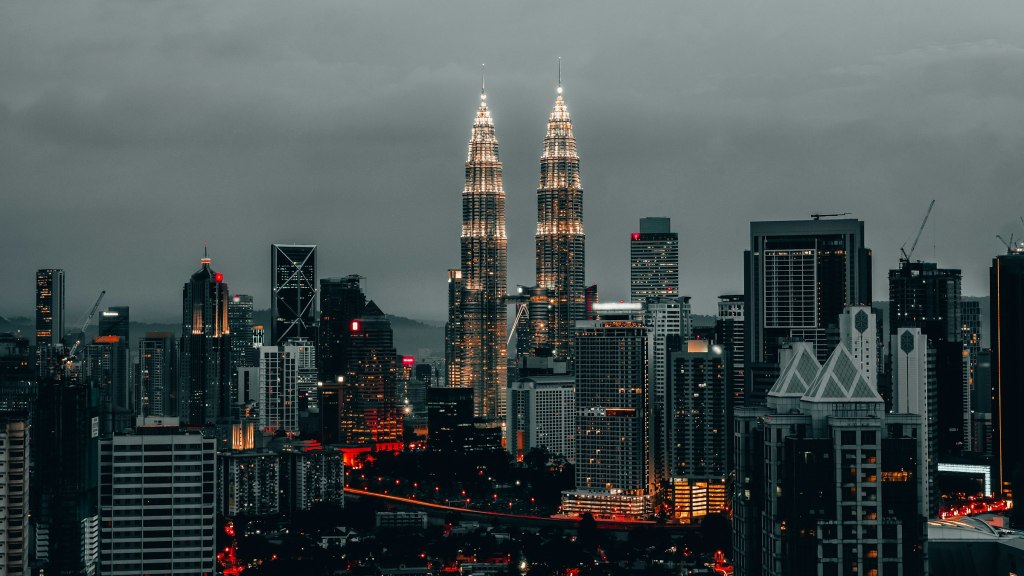 The Petronas Twin Towers rising above the Kuala Lumpur skyline