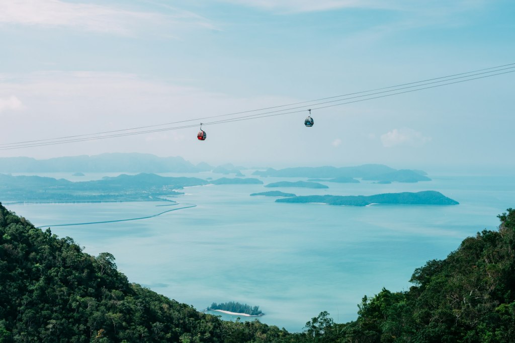 Green trees beside calm blue water on the coast of Langkawi, Malaysia
