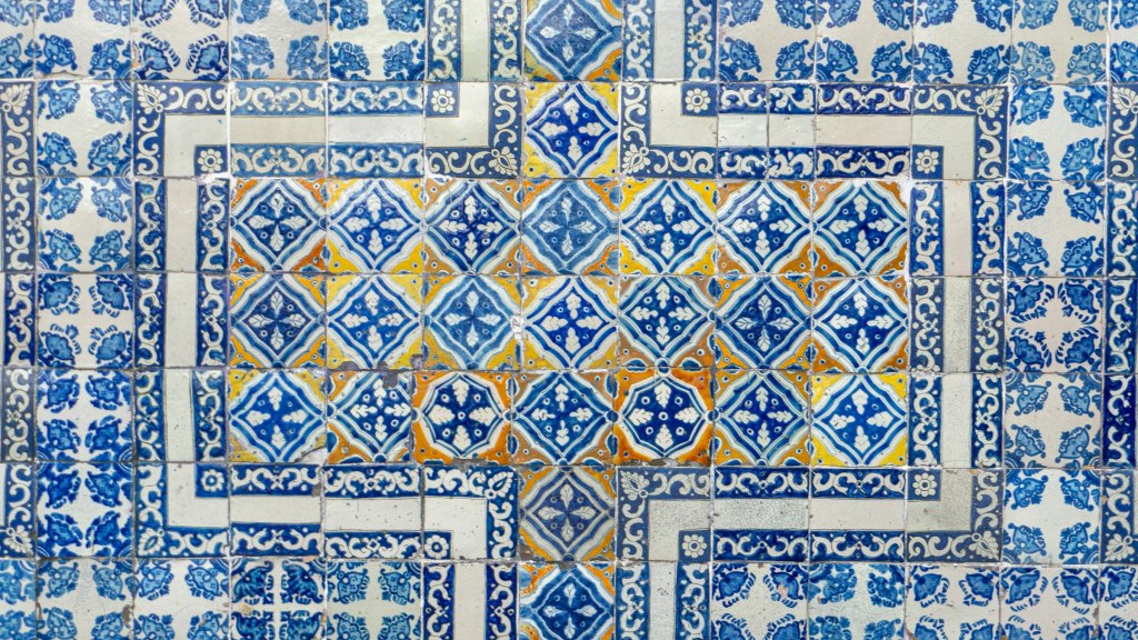 Blue and white azulejo tile wall with an intricate pattern in Lisbon