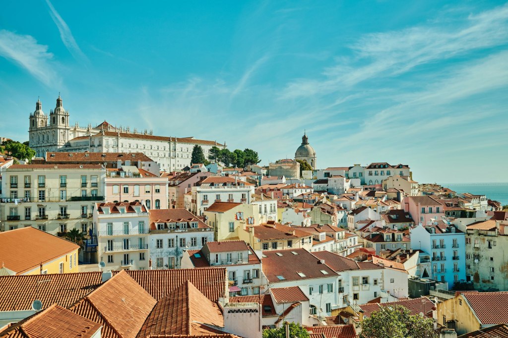 Lisbon rooftops and river seen from a hilltop viewpoint