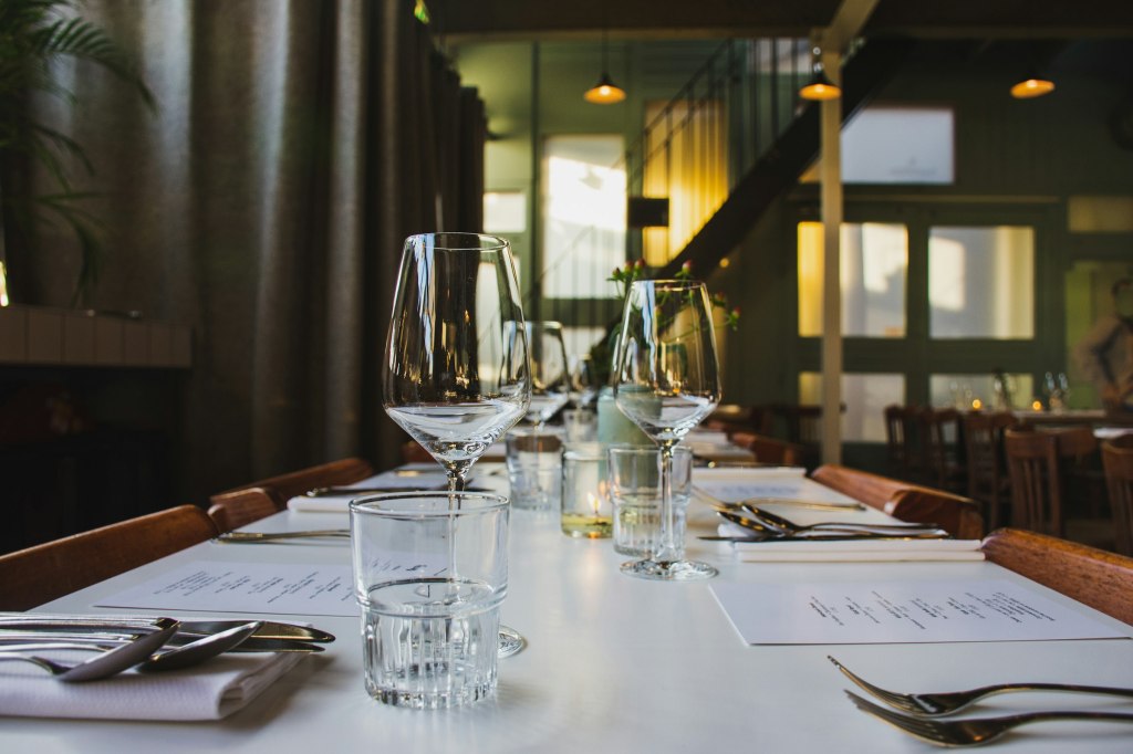 Elegant dining table set with clear wine glasses for a fine dining evening in London