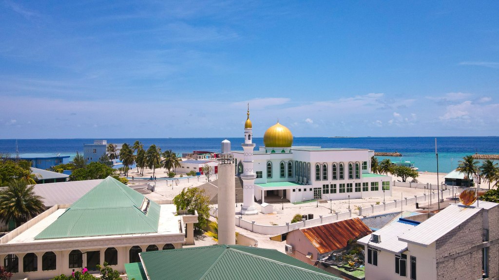 A domed building beside the water in Male, capital of the Maldives