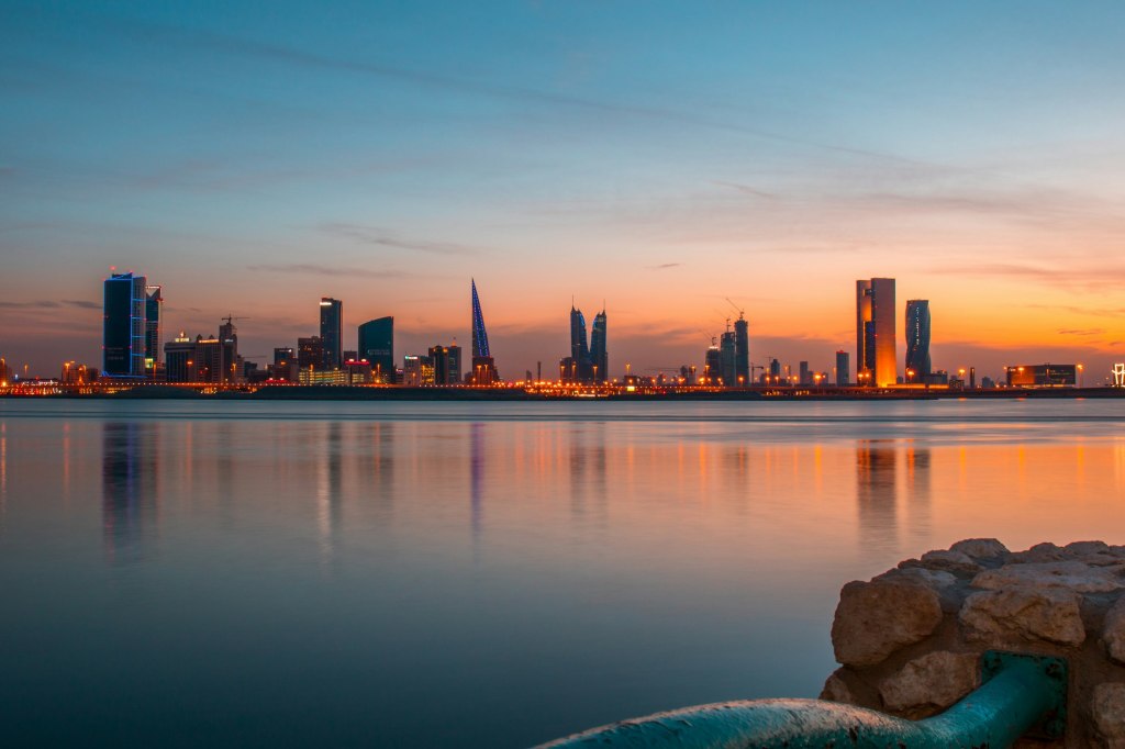 Manama skyline beside the water in Bahrain under a clear blue sky