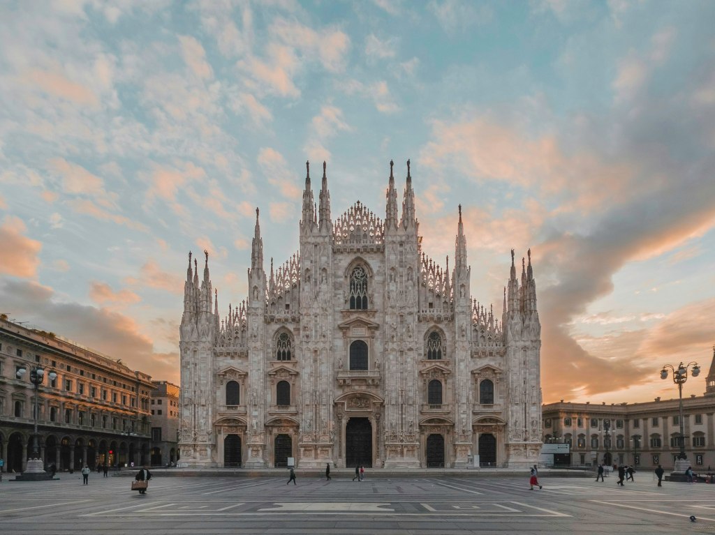 Milan Duomo under an orange and blue sky in Italy's fashion capital