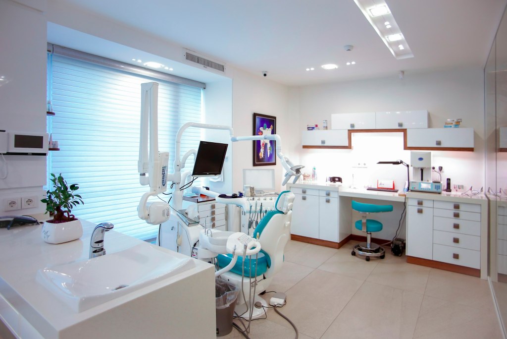 Bright modern dental office with a treatment chair and equipment