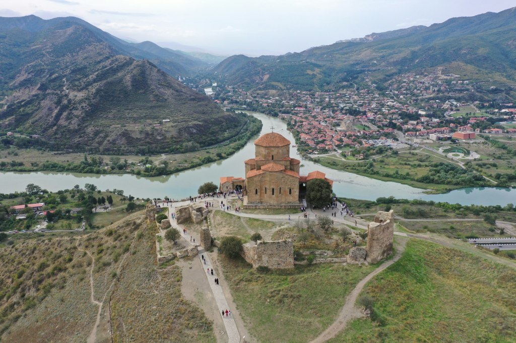 Aerial view of a historic church above the rivers at Mtskheta, Georgia