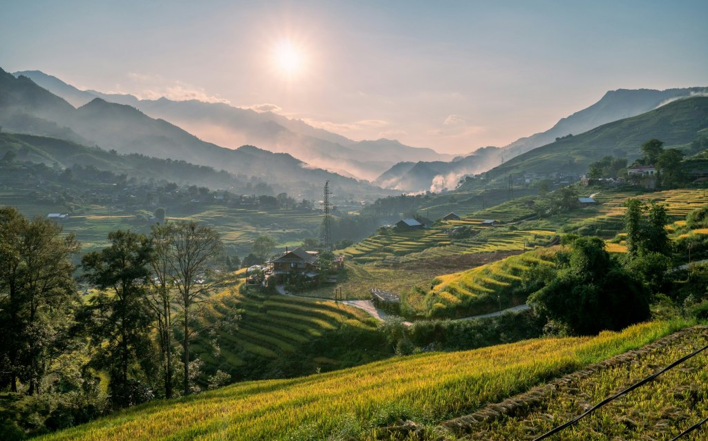Sunset over green rice terraces and mountains near Sapa, Vietnam