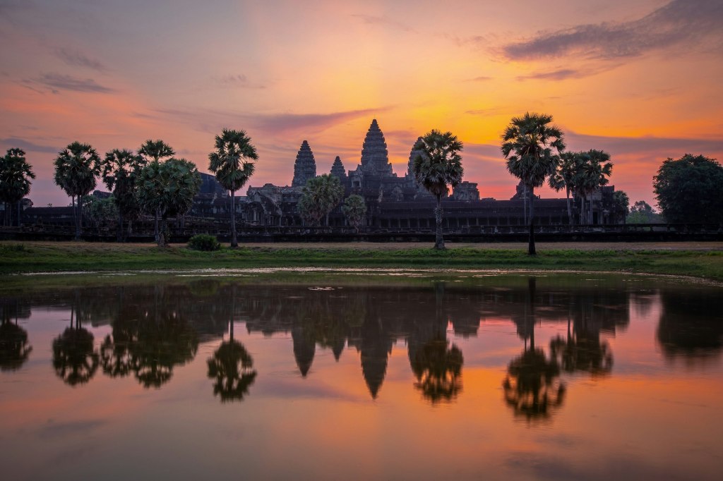 Sun setting over a wide stretch of water in Siem Reap, Cambodia
