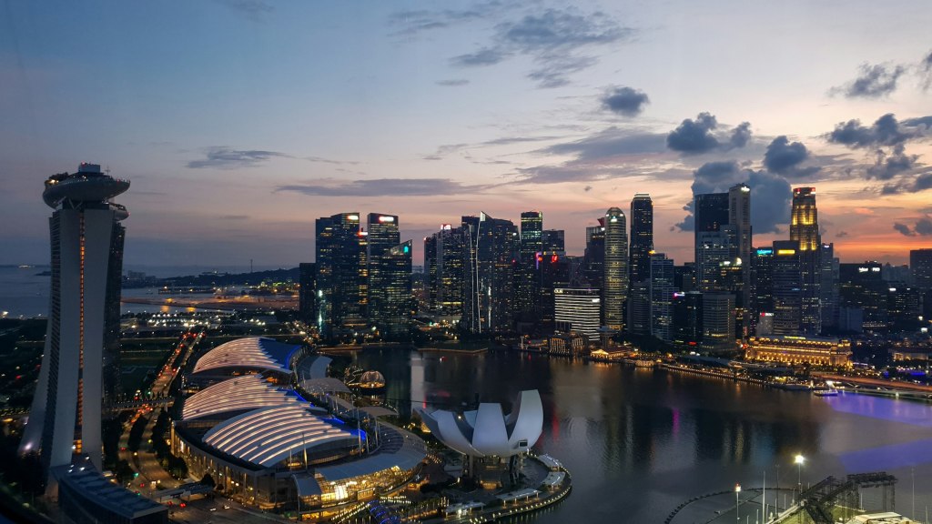 Singapore city skyline glowing at night