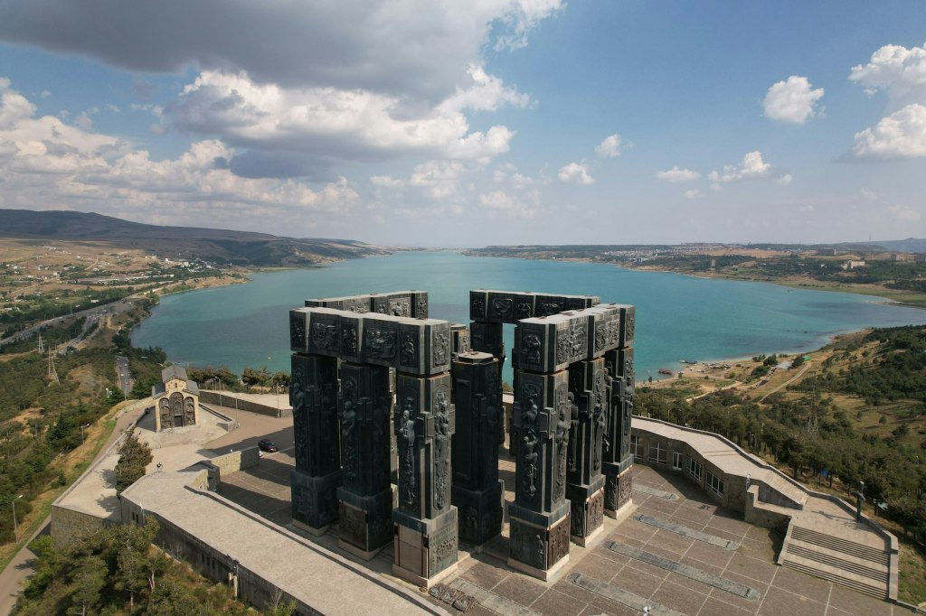 Aerial view of a Tbilisi building with a lake in the background, Georgia
