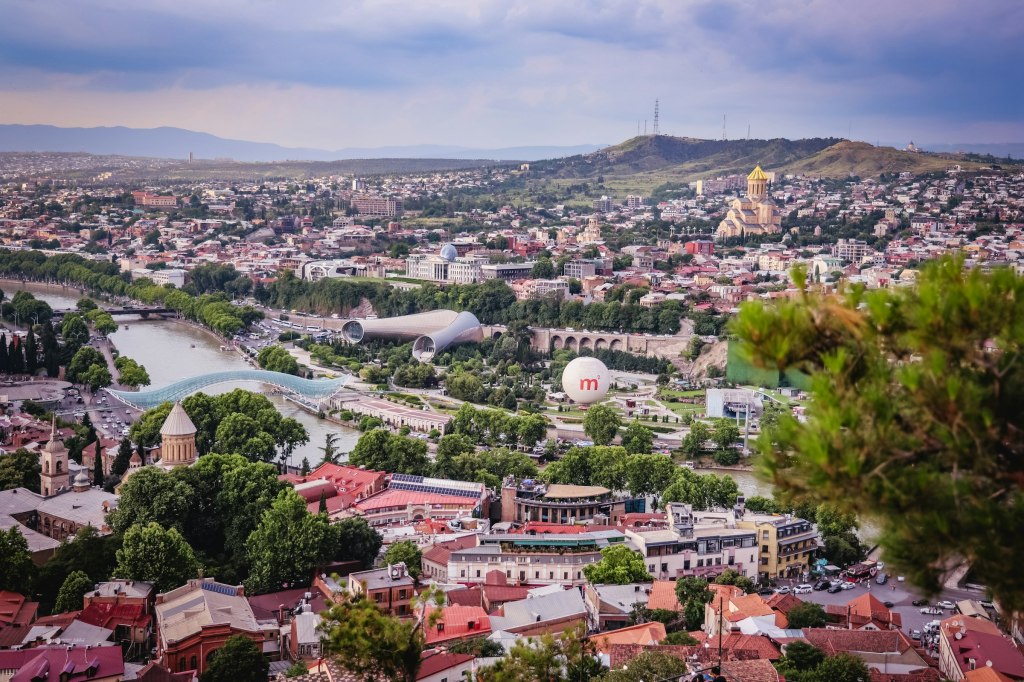 Panoramic view of Tbilisi, Georgia, with the Kura River winding through the city