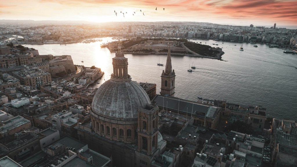 Domes and honey-colored buildings along the Valletta waterfront in Malta